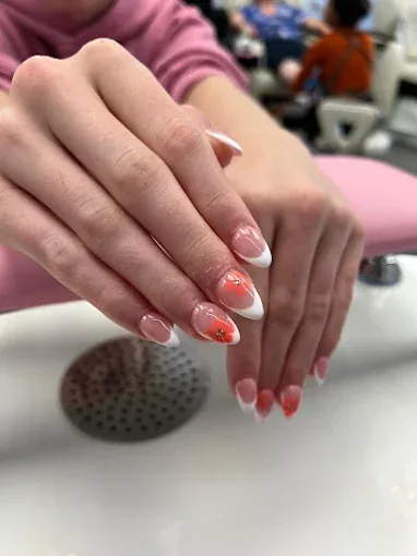 Almond nails with white French tips and coral flower art