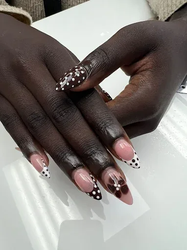 Brown and white polka dot nail design with French tips