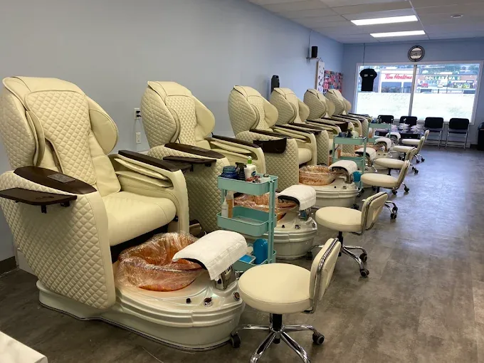 Row of cream massage pedicure chairs in the salon